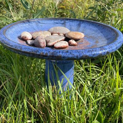 Blue bird bath with rocks