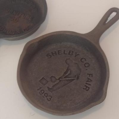 Set of Three Vintage Miniature Cast Iron Advertising Skillets and Ashtray