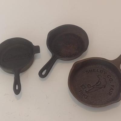 Set of Three Vintage Miniature Cast Iron Advertising Skillets and Ashtray