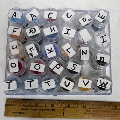 Vintage Seed Bead Storage Tray with individual lidded bottles labeled by previous owner