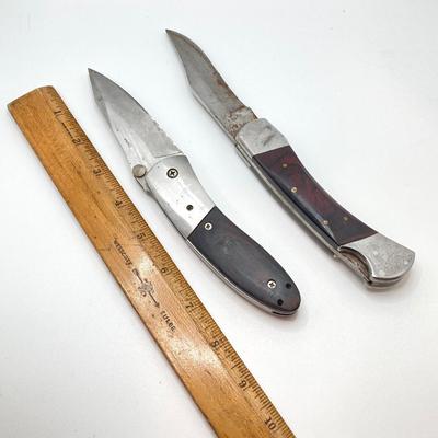 LOT 76: Pair of Folding Knives with Leather Sheaths