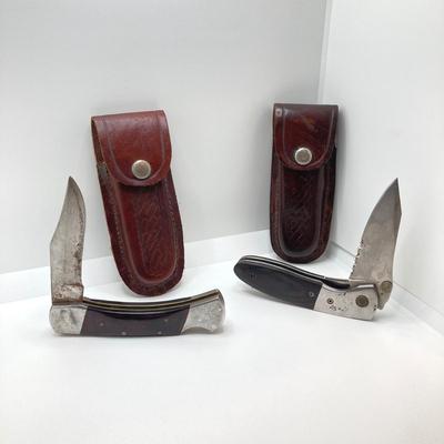 LOT 76: Pair of Folding Knives with Leather Sheaths