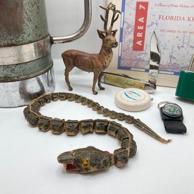 LOT 186: Vintage Sporting Goods Collection - Cast Iron Reindeer / Buck Figurine Made in Germany, Articulated Snake, Fishing Charts,...
