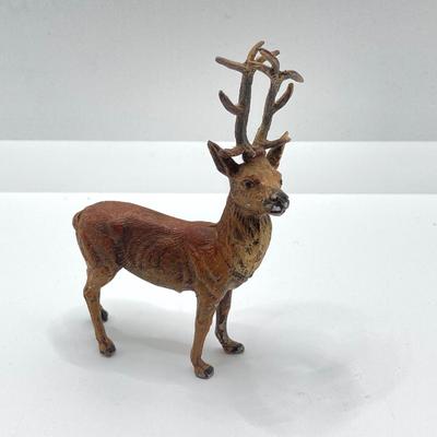 LOT 186: Vintage Sporting Goods Collection - Cast Iron Reindeer / Buck Figurine Made in Germany, Articulated Snake, Fishing Charts,...