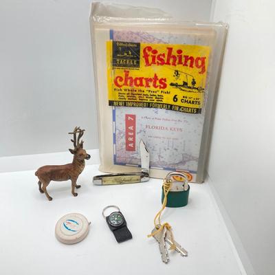 LOT 186: Vintage Sporting Goods Collection - Cast Iron Reindeer / Buck Figurine Made in Germany, Articulated Snake, Fishing Charts,...