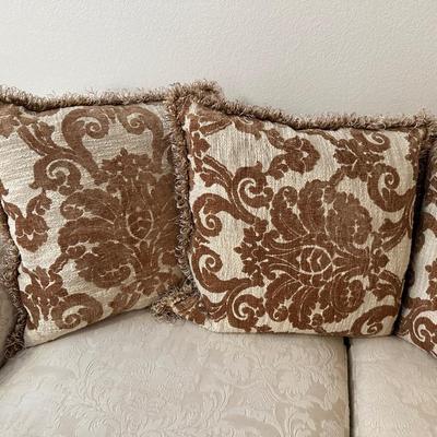 CREAM COLORED LOVESEAT WITH THROW PILLOWS