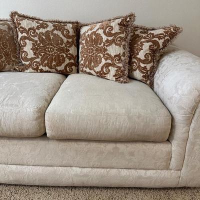CREAM COLORED LOVESEAT WITH THROW PILLOWS