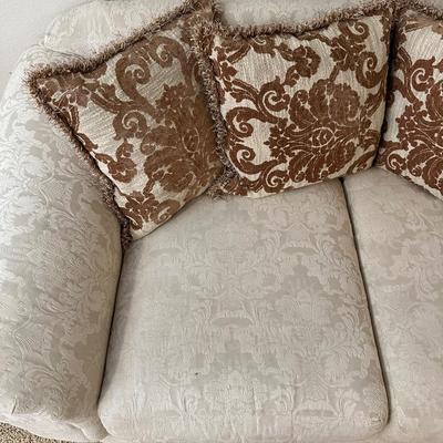 CREAM COLORED LOVESEAT WITH THROW PILLOWS