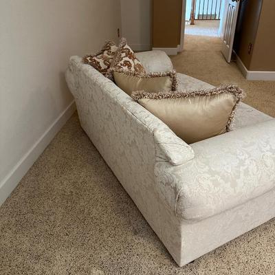 CREAM COLORED LOVESEAT WITH THROW PILLOWS
