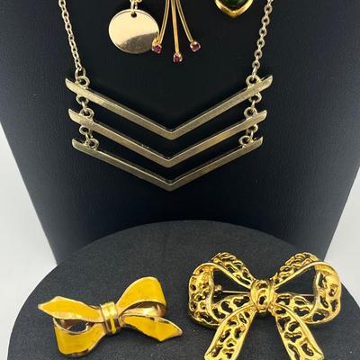 LOT 169J: Assorted Goldtone Necklaces PLUS Two Bow Pins: Avon and More!