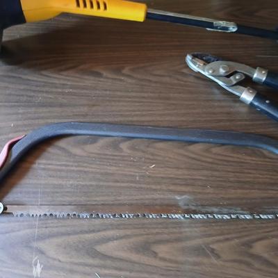 Electric weed eater, Loppers, and a bow saw