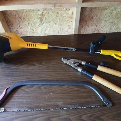Electric weed eater, Loppers, and a bow saw