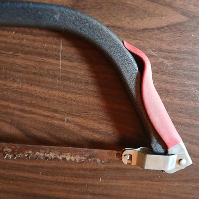 Electric weed eater, Loppers, and a bow saw