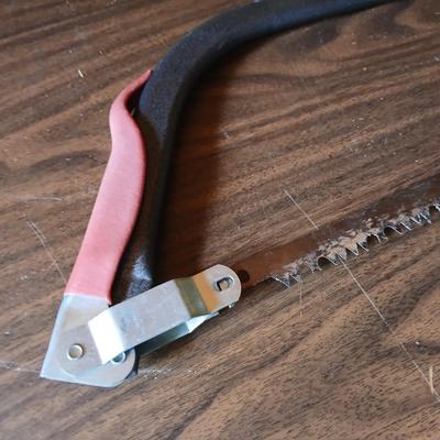 Electric weed eater, Loppers, and a bow saw