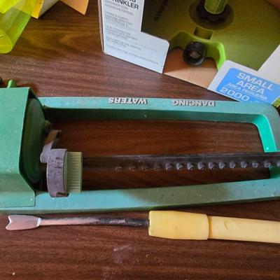 Yard / garden sprinklers and handtools with a bunch of vegetable seeds (some past the date)
