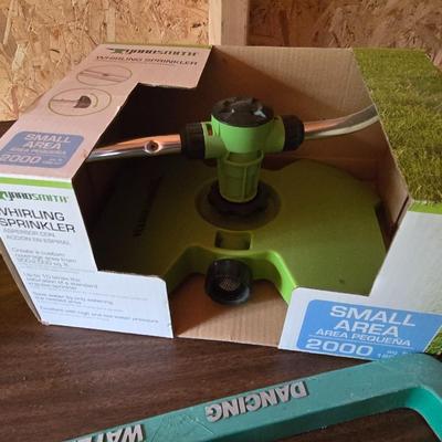 Yard / garden sprinklers and handtools with a bunch of vegetable seeds (some past the date)