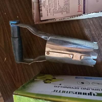 Yard / garden sprinklers and handtools with a bunch of vegetable seeds (some past the date)