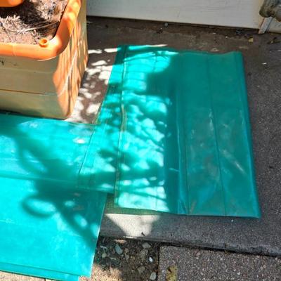 Three large orangish colored planters with tomato walls - self watering basin!