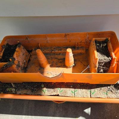 Three large orangish colored planters with tomato walls - self watering basin!