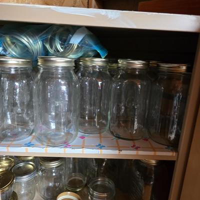 Metal corner cabinet full of mason jars