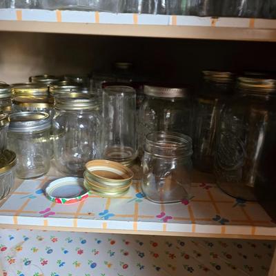 Metal corner cabinet full of mason jars