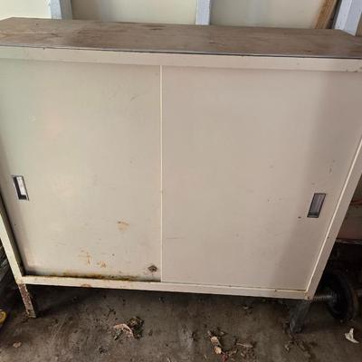 Metal storage cabinet with sliding doors
