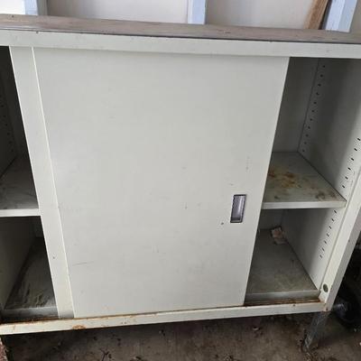Metal storage cabinet with sliding doors