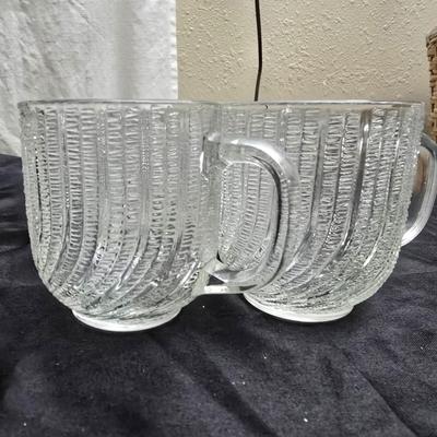 Etched rose and grapes glass plates with assortment of bowls and mugs