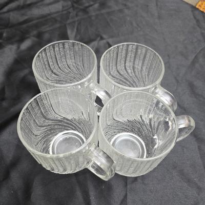 Etched rose and grapes glass plates with assortment of bowls and mugs