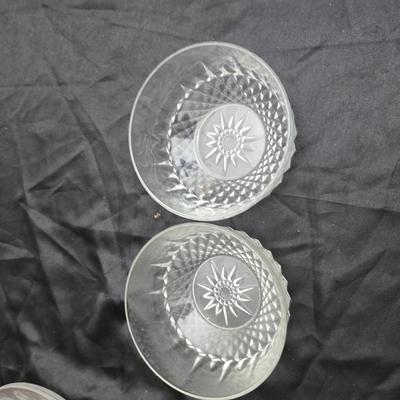 Etched rose and grapes glass plates with assortment of bowls and mugs