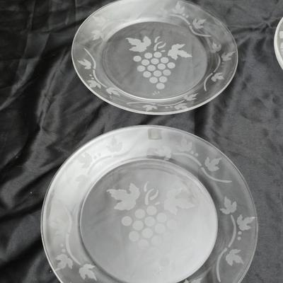 Etched rose and grapes glass plates with assortment of bowls and mugs
