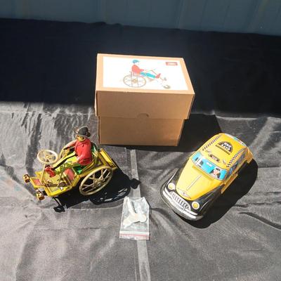 WIND UP MAN ON TRICK CART AND WIND UP TAXI CAB TOYS