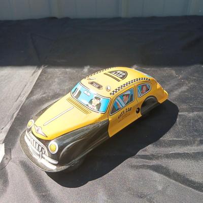 WIND UP MAN ON TRICK CART AND WIND UP TAXI CAB TOYS