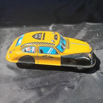 WIND UP MAN ON TRICK CART AND WIND UP TAXI CAB TOYS