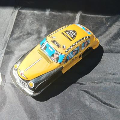WIND UP MAN ON TRICK CART AND WIND UP TAXI CAB TOYS