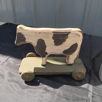 CLAY CROCK JUG AND WOODEN COW ON WHEELS