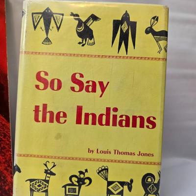 Native American books with a dream catcher, pottery and a native scraper tool