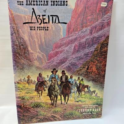 Native American books with a dream catcher, pottery and a native scraper tool