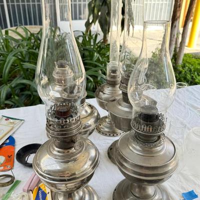 Antique oil lamps, chimneys, burners, wicks