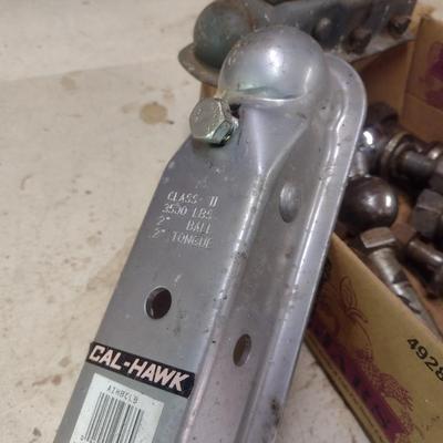 Assortment of Various Sized Trailer Ball Hitches and Hitch Attachments