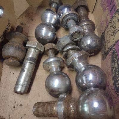 Assortment of Various Sized Trailer Ball Hitches and Hitch Attachments