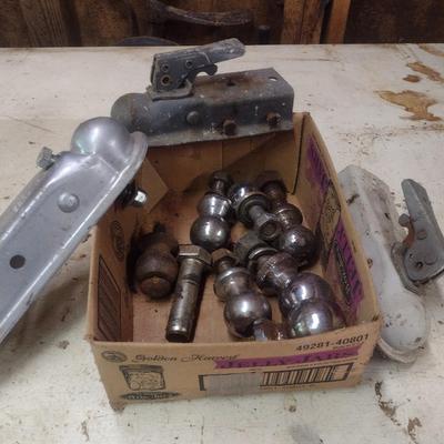 Assortment of Various Sized Trailer Ball Hitches and Hitch Attachments