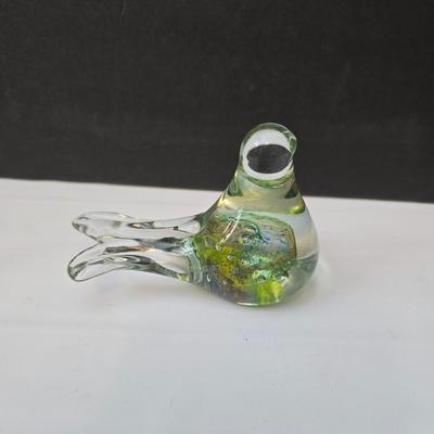 Blown glass bird and a clear glass squirrel candle holder