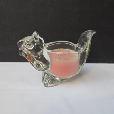 Blown glass bird and a clear glass squirrel candle holder