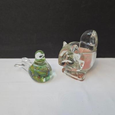 Blown glass bird and a clear glass squirrel candle holder