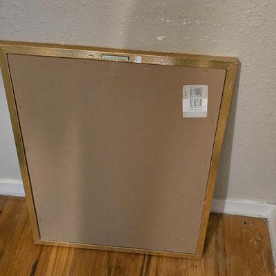 Adjustable armed floor lamp with gold framed wall art pair