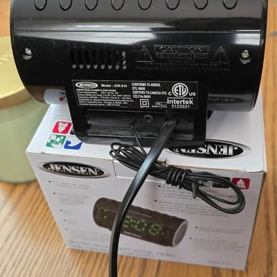Magazine rack end table with brand new Jensen digital alarm clock and a scented candle