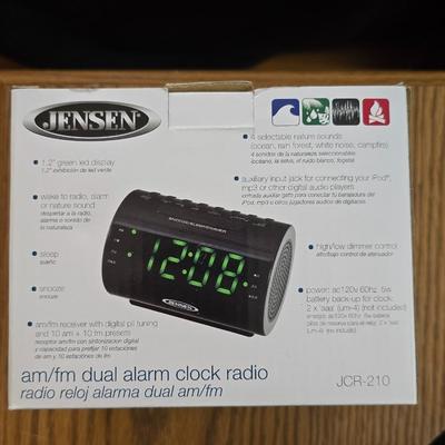 Magazine rack end table with brand new Jensen digital alarm clock and a scented candle
