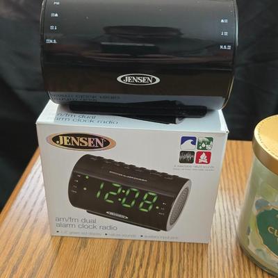 Magazine rack end table with brand new Jensen digital alarm clock and a scented candle