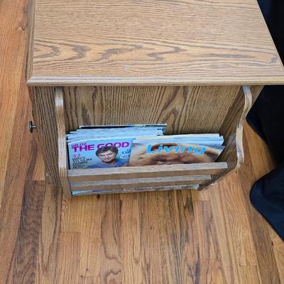 Magazine rack end table with brand new Jensen digital alarm clock and a scented candle
